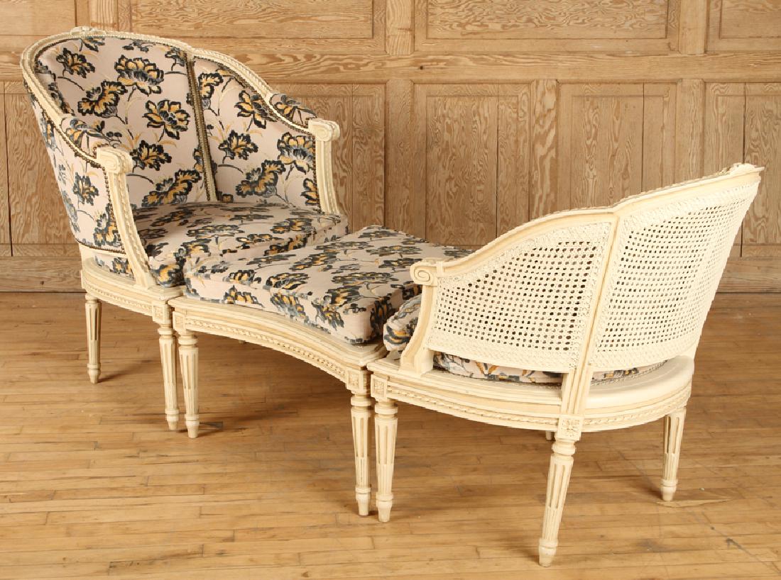 FRENCH LOUIS XVI PAINTED 3 PART CHAISE LOUNGE: A French Louis XVI style cream painted chaise lounge in three parts. The chairs with cane seats and loose cushions circa 1950. Ht: 37" Wd: 82" Dpth: 29"