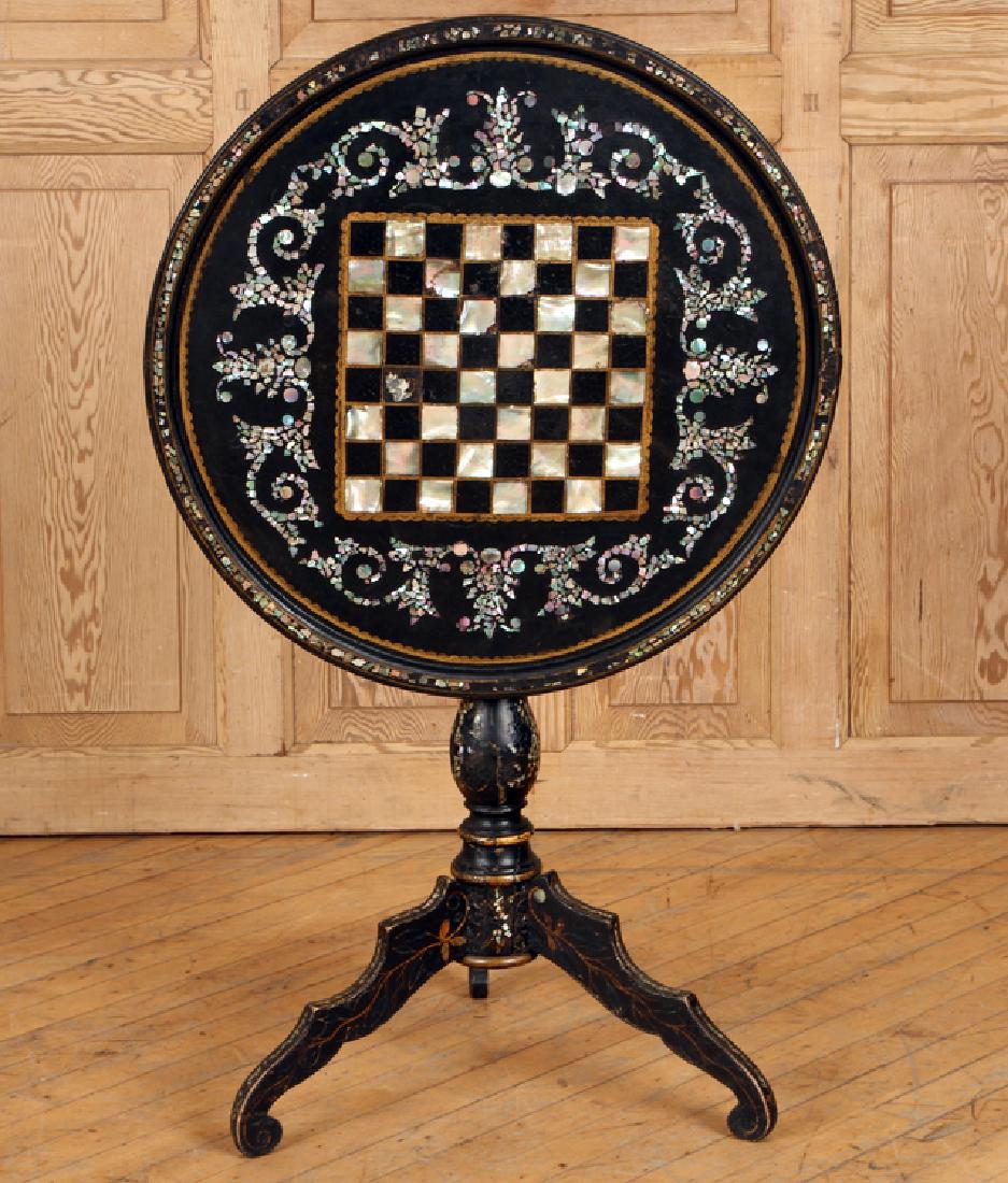 19TH C. FRENCH INLAID TILT TOP GAMES TABLE: A nineteenth century French paper mache and mother of pearl inlaid tilt top games table having a checkerboard top. Ht: 28" Dia: 25.5"