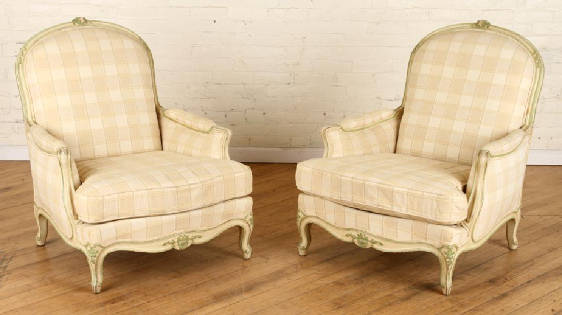 PAIR FRENCH LOUIS XV STYLE BERGERE CHAIRS C.1940: A pair of French Louis XV style upholstered bergere chairs having carved and painted frames circa 1940. Ht: 36" Wd: 30" Dpth: 33"