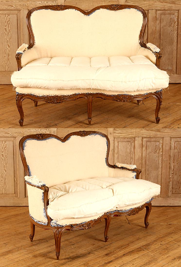 PAIR LOUIS XV STYLE WALNUT SETTEES CIRCA 1950: A pair of Louis XV stlye walnut settees having six legs circa 1950. Ht: 37" Wd: 48" Dpth: 28" Seat: 19"