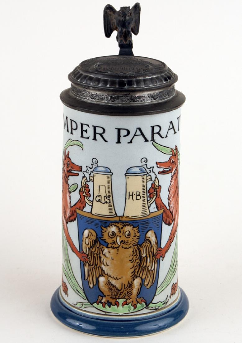 GERMAN METTLACH PORCELAIN BEER STEIN #2004 MARKED: A German Mettlach porcelain lidded beer stein, owl on shield with wolf hounds, #2004, 0.5 liter, marked to base. Having Heidelberg view in relief to cover.
