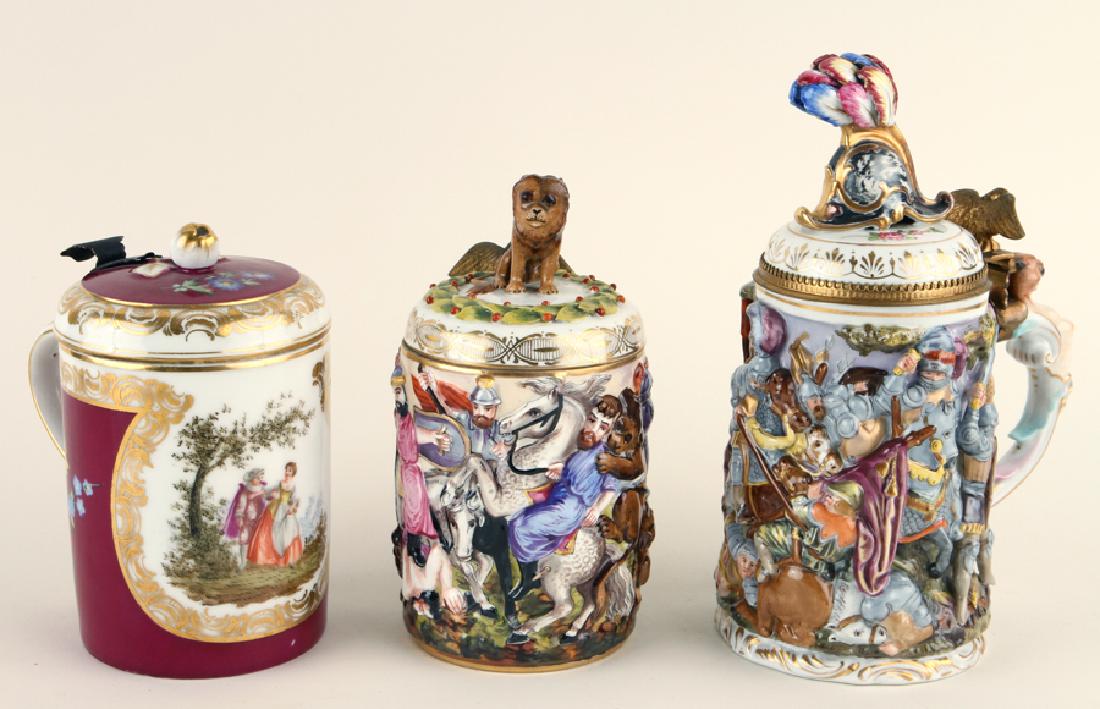 THREE MARKED PORCELAIN BEER STEINS CAPODIMONTE: A lot of three marked porcelain beer steins including Capodimonte. Ranging in height from 7.25" to 10.25".
