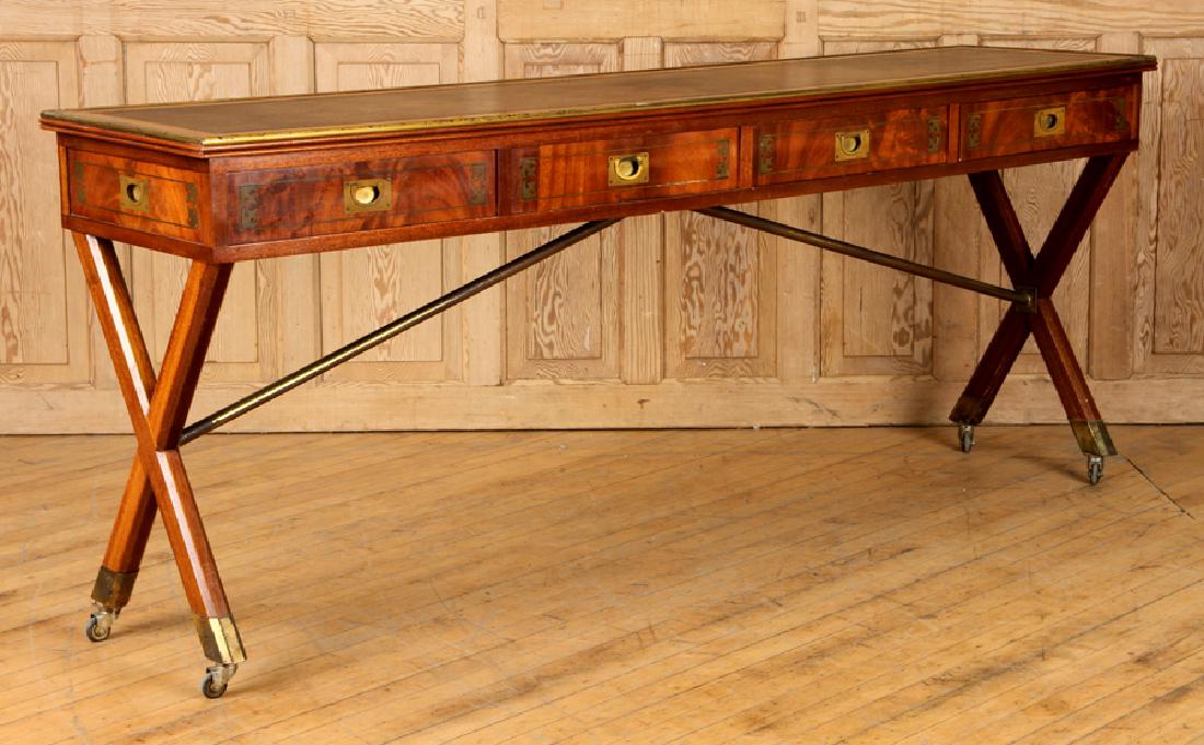 MAHOGANY CAMPAIGN STYLE SOFA OR CONSOLE TABLE: A large and unusual mahogany Campaign style sofa table or console table circa 1950. Having a brass bound leather top over four drawers with brass inlay. The backside having four faux drawers and the w
