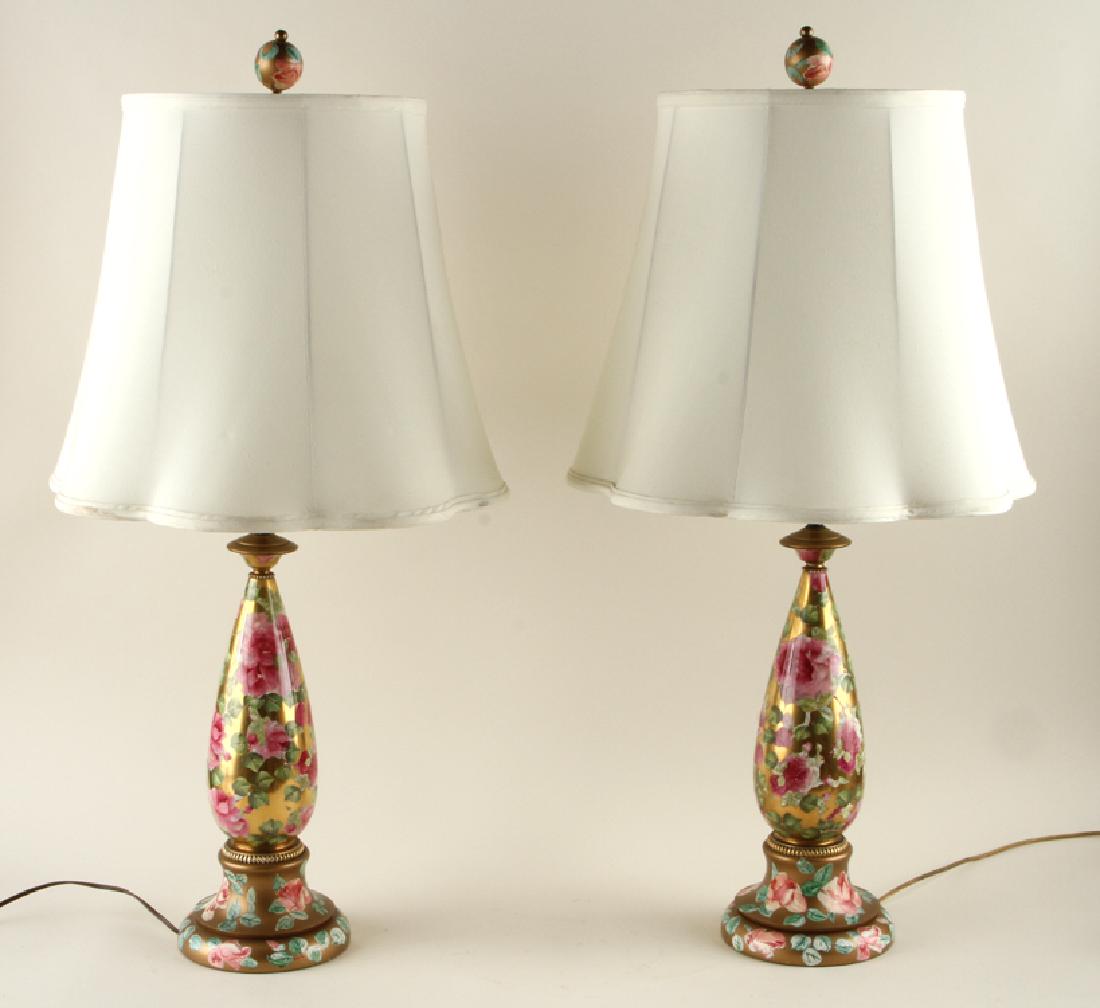 PAIR CONTINENTAL PORCELAIN ONE LIGHT TABLE LAMPS: A pair of Continental hand painted porcelain one light table lamps having hand painted porcelain standard on wood bases. Ht: 18.25"