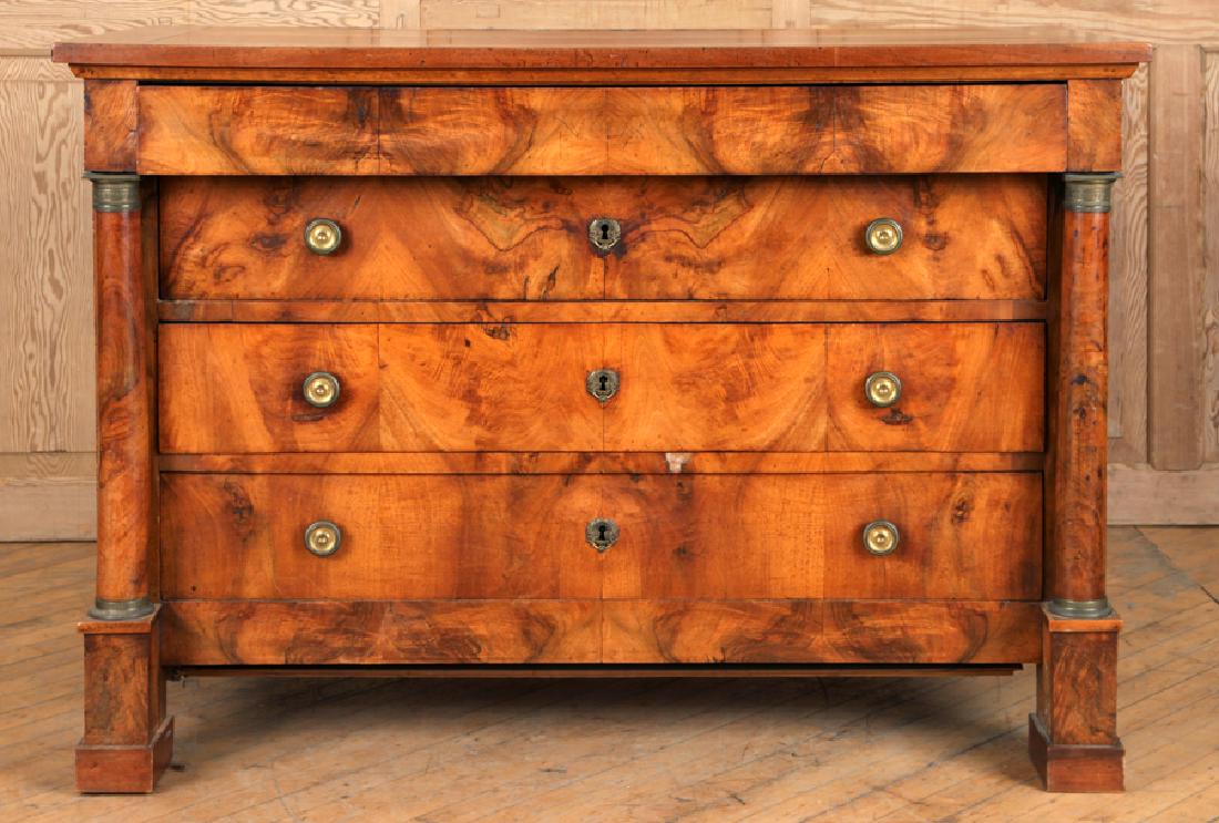 FRENCH 19TH CENT. WALNUT EMPIRE STYLE COMMODE: A French nineteenth century walnut four drawer Empire style commode having full round bronze mounted columns. Ht: 36" Wd: 51" Dpth: 25"