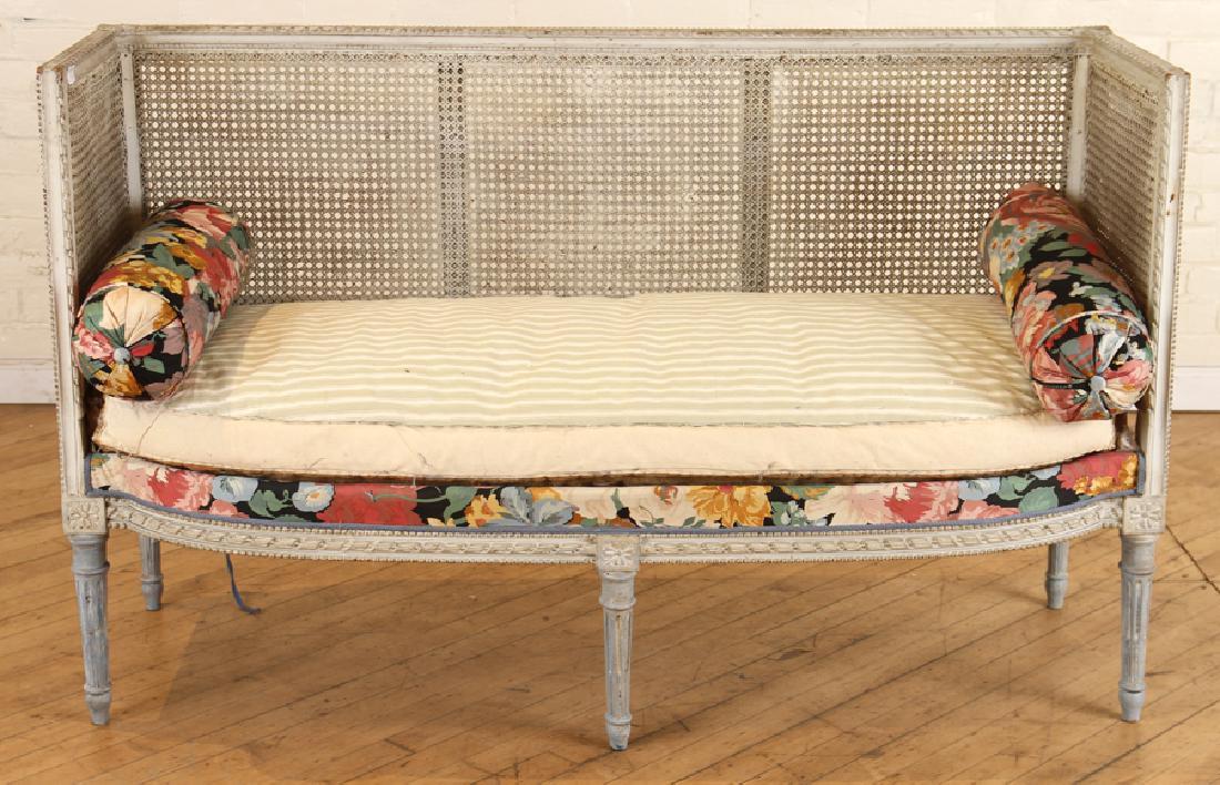 FRENCH LOUIS XVI STYLE CANAPE CIRCA 1900: A French Louis XVI style canape circa 1900. Having caned back, double caned ends and carved frame resting on fluted legs. Ht: 33.5" Wd: 54" Dpth: 23" Seat: 18"