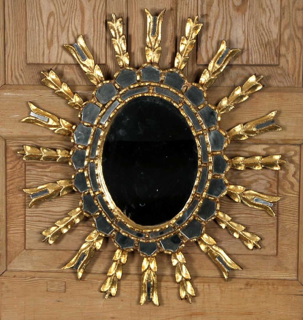 GILT WOOD STARBUST MIRROR MANNER OF LINE VAUTRIN: A gilt wood starburst mirror in the manner of Line Vautrin. Ht: 23" Dia: 20"