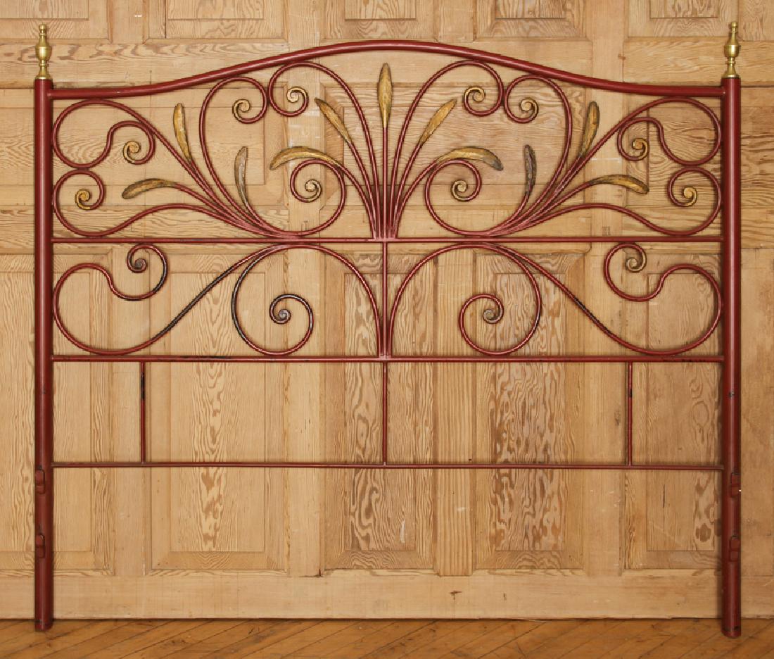 RED FRENCH IRON HEAD BOARD CIRCA 1950: A red French iron head board having scroll form decoration, gilt leaves and brass finials circa 1950. Ht: 53" Wd: 63"