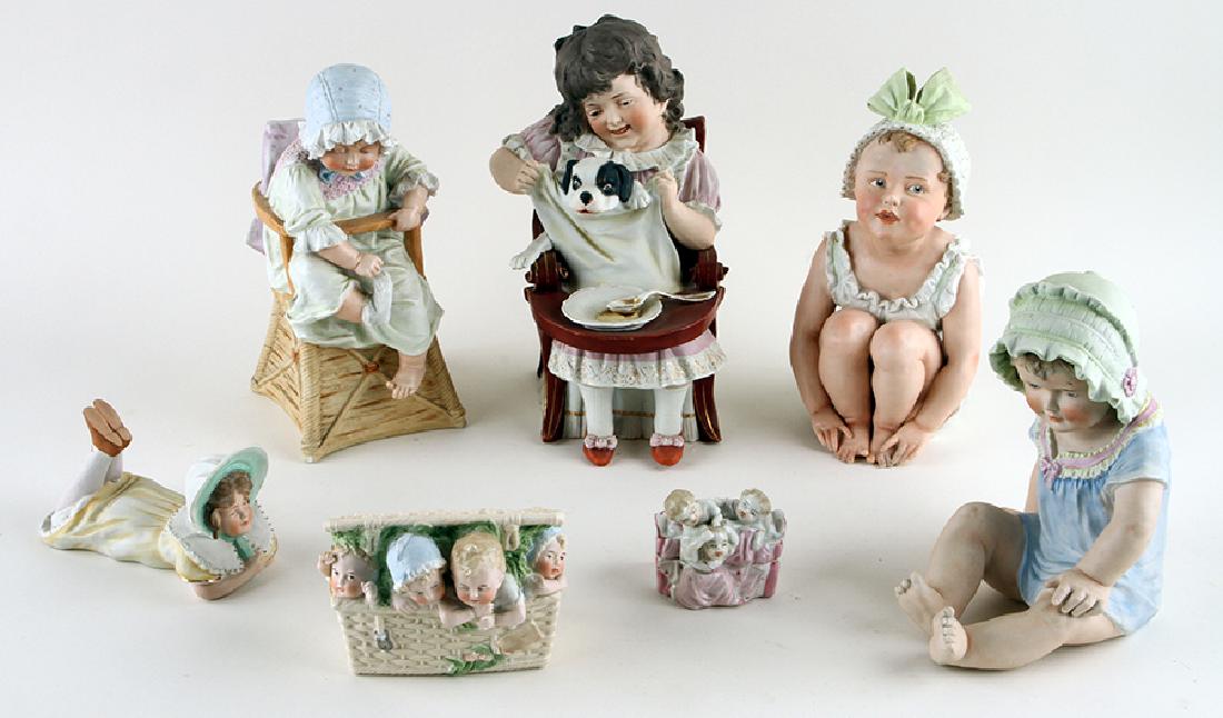 COLLECTION OF FIVE CONTINENTAL PORCELAINS & OTHER: A collection of five Continental porcelain piano babies along with a planter and small covered box. To include: The piano baby figures ranging in size from 3.25" to 12" The planter: 6" The covered box