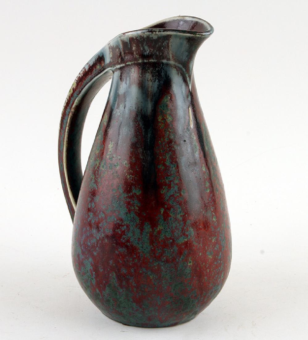 PIERRE-ADRIEN DALPAYRAT ART NOUVEAU PITCHER: Pierre-Adrien Dalpayrat (French, 1844-1910) An Art Nouveau glazed ceramic pitcher in oxblood and verdigris glaze, incised to base. Ht: 10.25" Dia: 6.5"