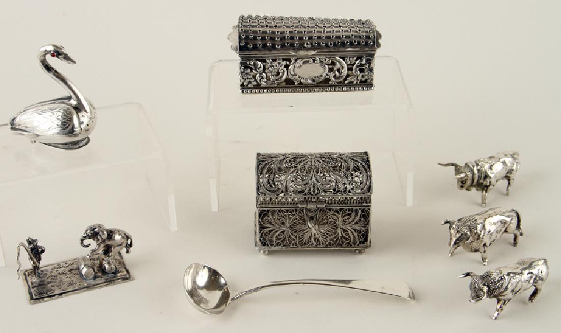 EIGHT SILVER TABLE ARTICLES 6.89 TROY OZ: An eight piece collection of silver table articles, total weight: 6.89 troy oz. To include: Three bull figures One circus elephant One American sterling nutmeg grater A swan form pepper pot A small la