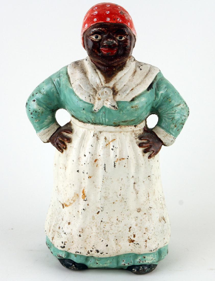 PAINTED CAST IRON AUNT JEMIMA DOORSTOP BY HUBLEY: A painted cast iron Aunt Jemima doorstop by Hubley, marked to interior. Ht: 12" Wd: 7.25" Dpth: 4.5"