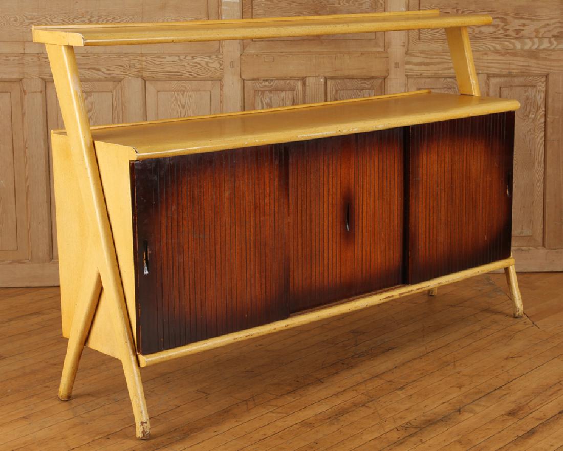 BLONDE MAHOGANY CREDENZA MANNER VLADIMIR KAGAN: A mid century modern blonde mahogany two tier credenza having three sliding doors in the manner of Vladimir Kagan circa 1960. Ht: 43" Wd: 66" Dpth: 17"