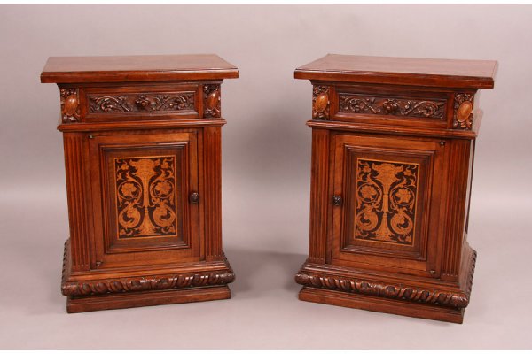 Pair Italian antique walnut side cabinets: Very good pair of Italian side cabinets circa 1890. High relief carved drawer over door with pen work of face, scrolls, and flowers. Flanked by fluted columns on raised egg and dart base. Minor surfac