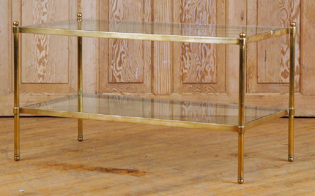 TWO TIER BRASS GLASS COFFEE TABLE CIRCA 1970: A two tier brass and glass coffee table with ball finials circa 1970. Ht: 20.5" Wd: 37" Dpth: 19"