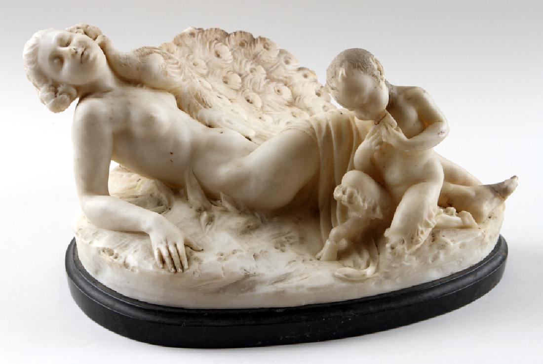 ITALIAN ALABASTER SCULPTURE OF RECLINING WOMAN: An Italian alabaster sculpture of a reclining woman with peacock and saytre. Incised to back of sculpture, Altieri, Florence Ht: 8.5"