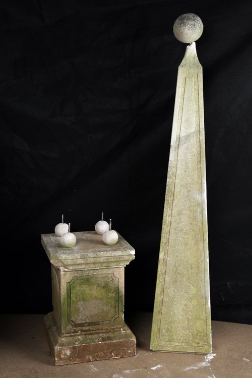 CAST STONE OBELISK RAISED ON FOUR SPHERES: A cast stone obelisk raised on four spheres, the whole resting on plinth base. Ht: 95" Wd: 18" Dpth: 18"