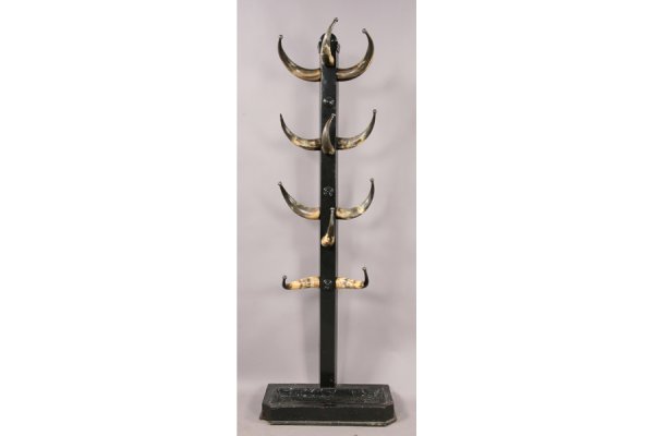 Antique horn & wood hall rack: Antique horn and wood hall rack circa 1910. A central molded square post with metal tipped cattle horn coat hooks and lower plate for umbrellas. Later paint, one tip missing. See pair of horn chairs l