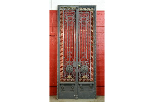 Regal pair iron & bronze entry doors gates: Pair of iron and bronze entry gates and frame circa 1890. The iron panels having a central medallion surrounded by a bronze Greek key border. Great for your Manhattan brown stone. Ht: 126 Width: 42" *