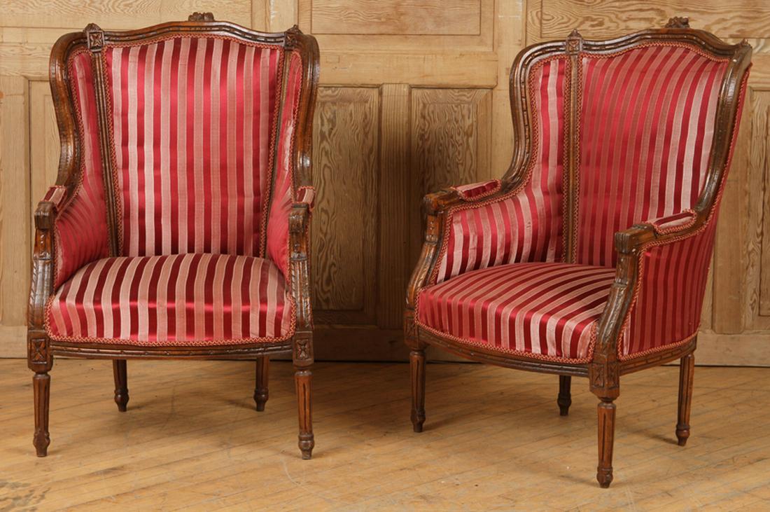 PAIR CARVED & UPHOLSTERED BERGERES LOUIS XVI: A pair of carved and upholstered bergere chairs in the Louis XVI style. Ht: 41" Wd: 27" Dpth: 28" Seat: 16"