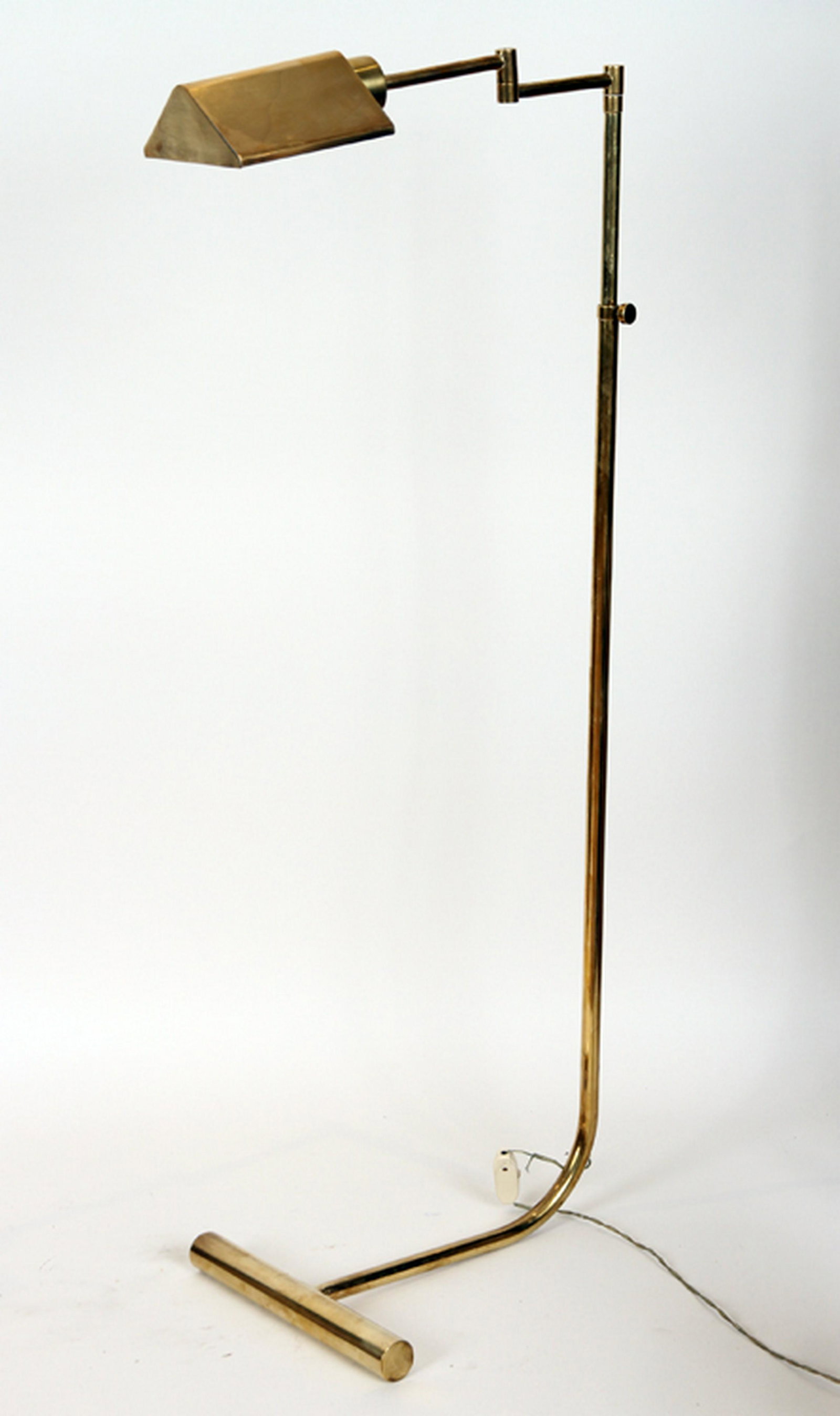 BRASS FLOOR LAMP BY CEDRIC HARTMAN: A brass floor lamp by Cedric Hartman. Having an adjustable standard, a swing arm and a swivel shade. Ht: 53" Wd: 12" Dpth: 23"