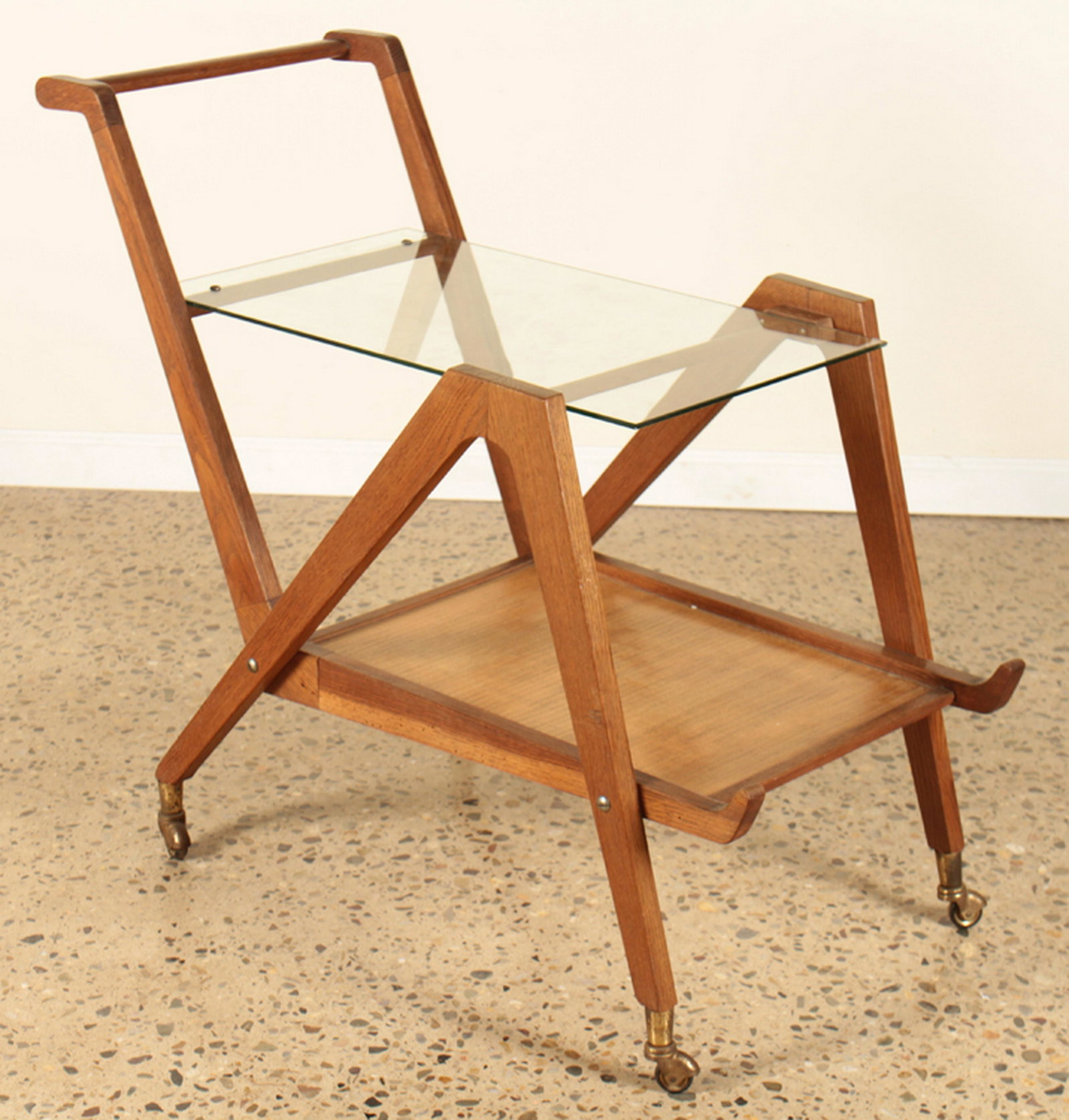 ITALIAN MID CENTURY MODERN GLASS WOOD BAR CART: An Italian mid century modern two tier glass and wood bar cart circa 1960. Ht: 31" Wd: 16.5" Dpth: 36"