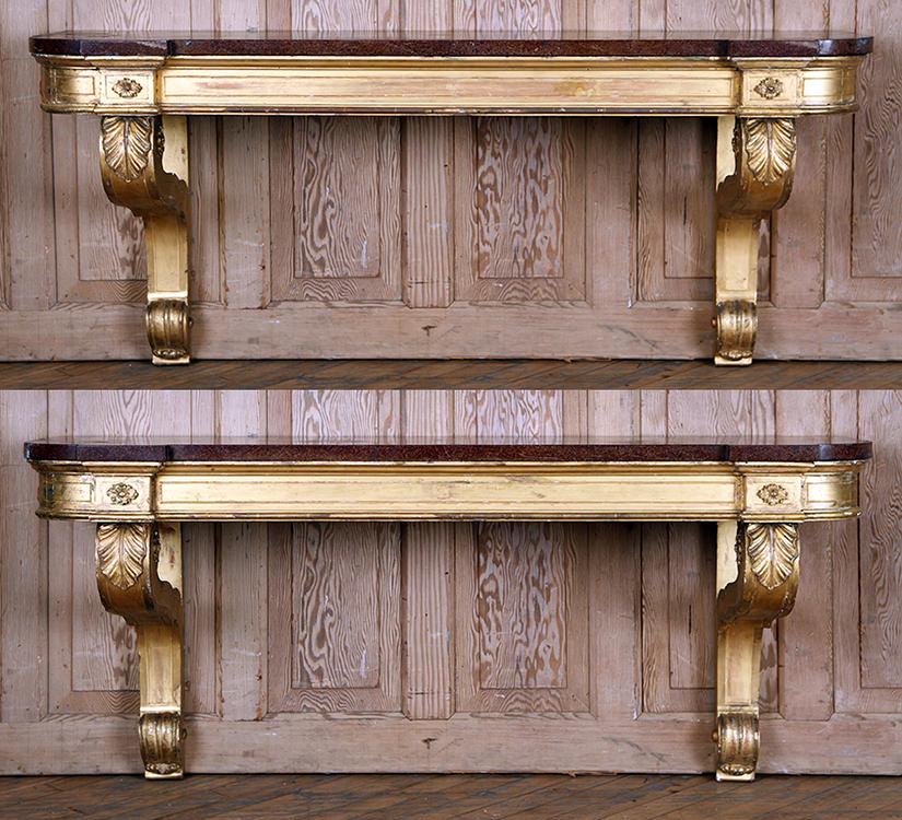PAIR 19TH C GILT WOOD WALL MOUNTED CONSOLE TABLES: A pair of nineteenth century gilt wood wall mounted console tables having faux marbleized slate tops. Ht: 24" Wd: 54" Dpth: 16"