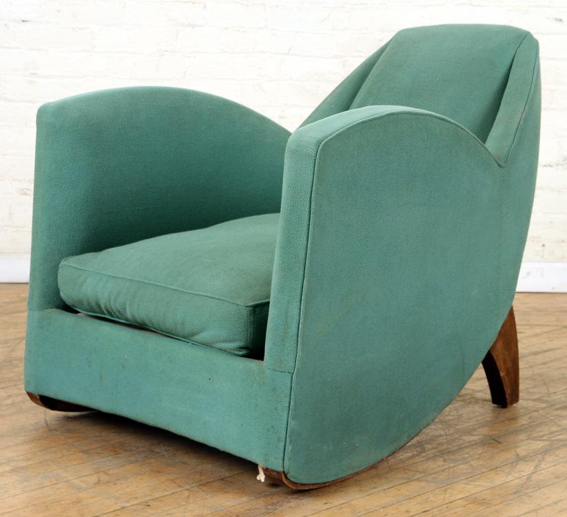 ART DECO CLUB CHAIR ANGULAR MAHOGANY LEGS C.1920: A swept back Art Deco club chair having continuous arms and angular mahogany legs circa 1920. Ht: 30" Wd: 28.5" Dpth: 36"