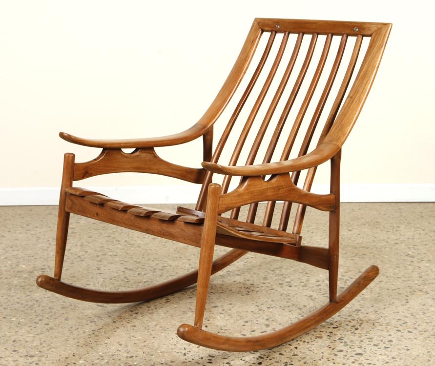 MID CENTURY MODERN MAHOGANY ROCKING CHAIR: A mid century modern mahogany rocking chair with rolled arms and a slat back. Ht: 35" Wd: 25.5" Dpth: 38" Seat: 17"