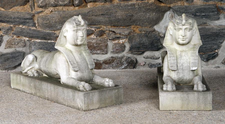 PAIR CAST STONE EGYPTIAN STYLE RECLINING SPHINX: A pair of cast stone Egyptian style reclining sphinx. Ht: 20" Wd: 10.5" Dpth: 32"