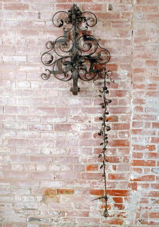 ANTIQUE WROUGHT IRON DOOR CHIME AND KNOCKER: A monumental and elaborate antique wrought iron door chime and knocker having floral and foliate decoration. The long arm can be pulled to activate the bell or the end can be used as a knocker. Ht: 70