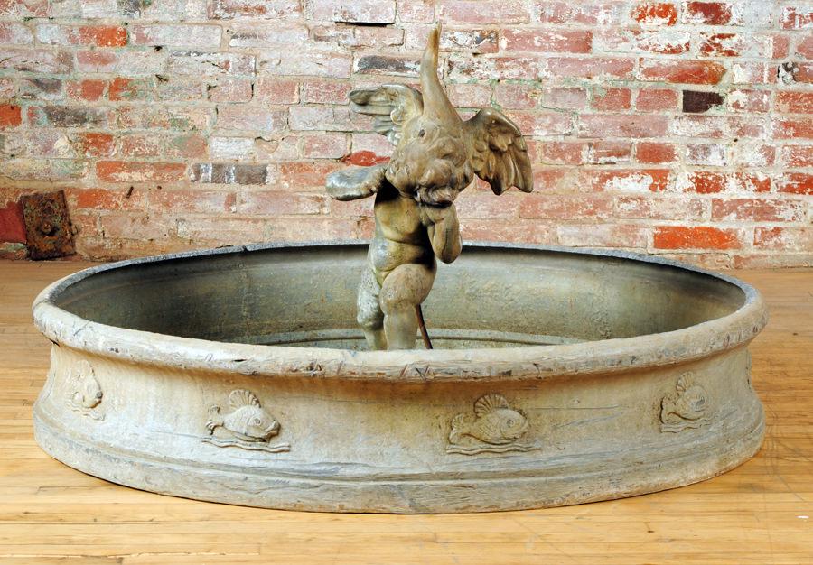 LEAD GARDEN FOUNTAIN WITH LEAD FIGURE OF A BOY: A lead garden fountain with lead figure of a boy holding a goose circa 1910. The basin having naturalistic decoration with swimming fish. Figure only: Ht- 28" Basin only: Ht- 9.5" Dia- 48" Provenance: