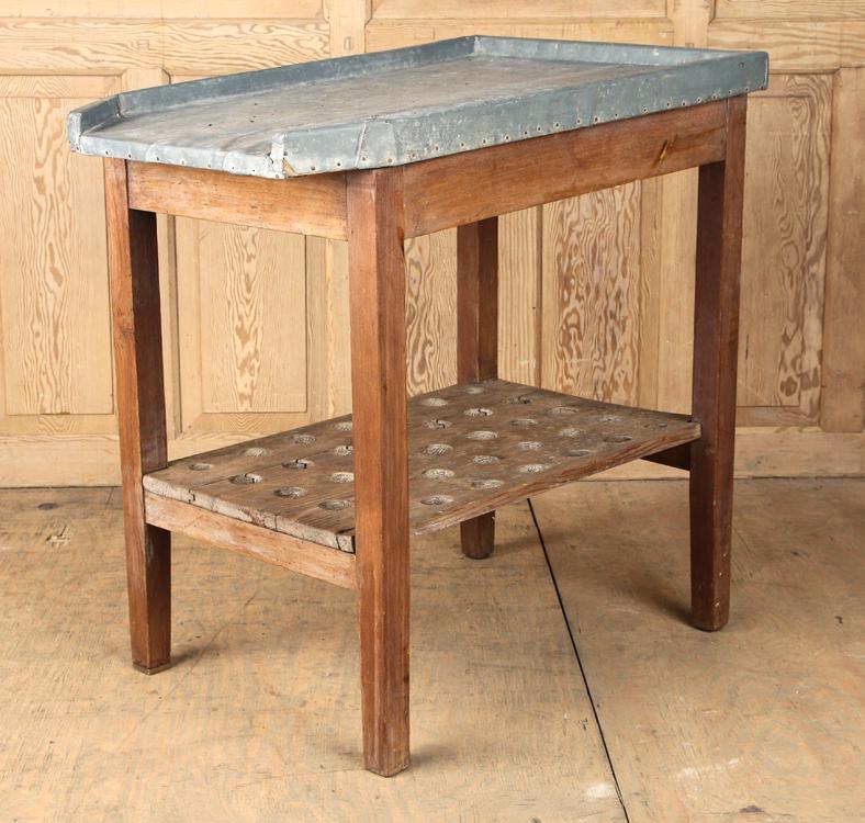 RUSTIC WOOD POTTING TABLE WITH ZINC TOP: A rustic wood potting table having a zinc top and a medial shelf drilled to accept tools. Ht: 36.25" Wd: 35.5" Dpth: 23.5"