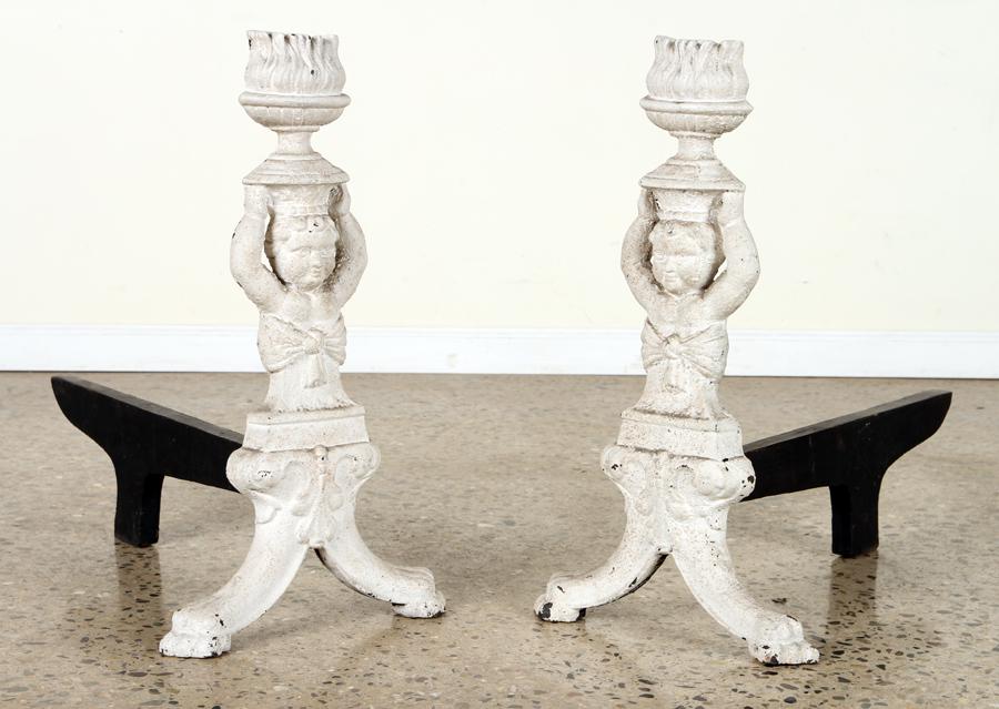 PAIR OF CAST IRON CHERUB FORM ANDIRONS: A pair of cast iron cherub form andirons each holding urns over head. Ht: 25" Wd: 13.75" Dpth: 27"