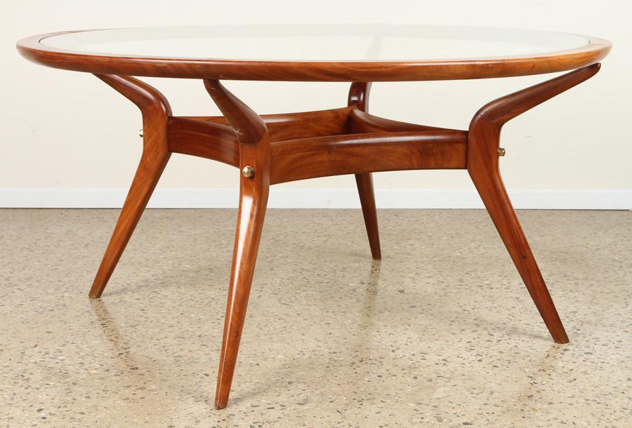 MAHOGANY GLASS DINING TABLE INSET GLASS C.1960: A mid century modern mahogany and glass dining table having inset circular glass resting on splayed legs circa 1960. Ht: 30" Dia: 60"