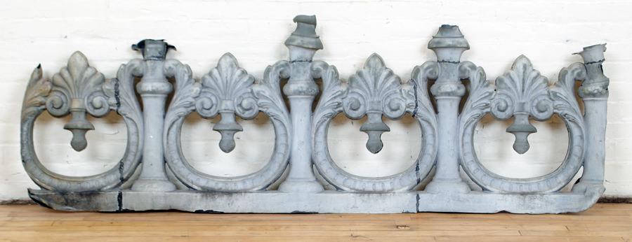 ANTIQUE ZING ROOF DECORATION ELEMENT FLEUR DE LIS: An antique zinc roof decoration element having stylized fleur de lis decoration in wishbone surround. Ht: 24" Wd: 72" Dpth: 2.5"