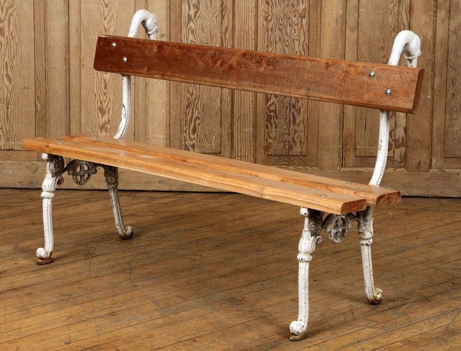 WOOD & CAST IRON PARK BENCH SWAN FORM SUPPORTS: A wood and cast iron park bench having swan form supports. Ht: 29.5" Wd: 47.5" Dpth: 19"