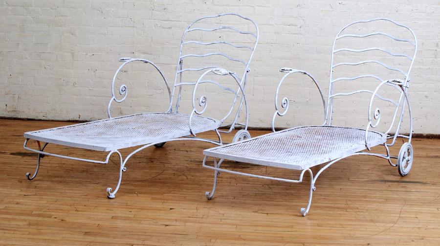 SET OF 4 PAINTED CAST IRON GARDEN SEATS: A set of four painted cast iron garden seats including two chaise lounges and a matching chair and ottoman. Ht: 38" Wd: 65" Dpth: 32"