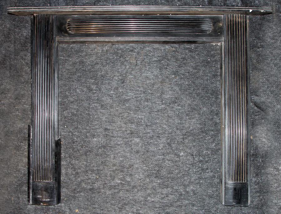 IRISH BLACK 19TH CENT. MARBLE MANTLE REEDED LEGS: An interesting Irish black nineteenth century marble mantle having reeded legs and center tablet. Inner dimensions: 41.5" x 42" Ht: 50" Wd: 64.5" Dpth: 10.5"