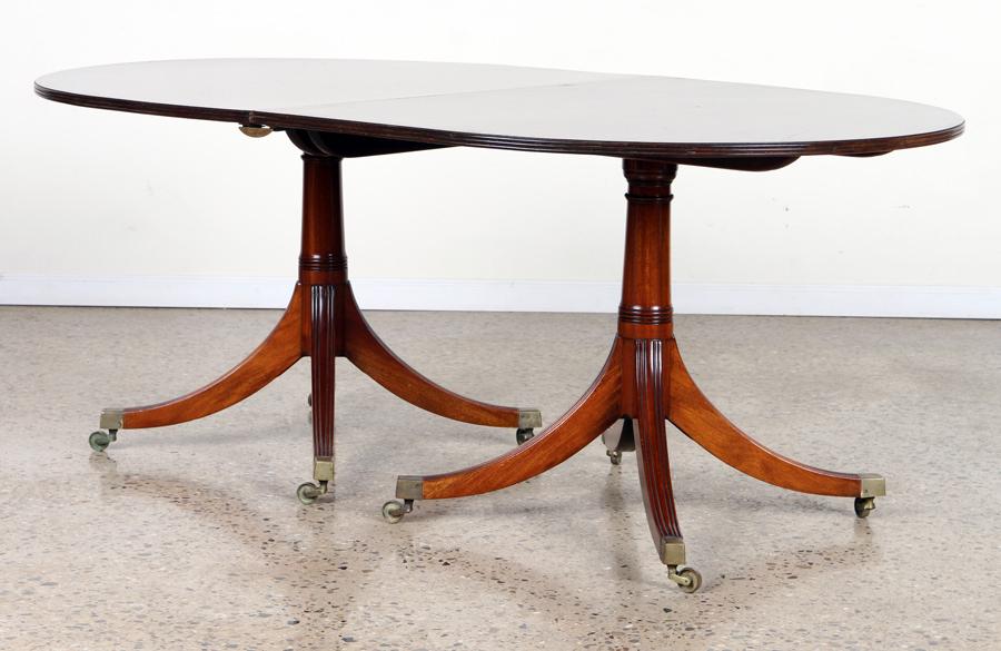 DUNCAN PHYFE STYLE MAHOGANY DINING TABLE: A Duncan Phyfe style mahogany double pedestal dining table with two matching leaves. Leaves extend table to 108" wide. Ht: 29" Wd: 72" Dpth: 44"