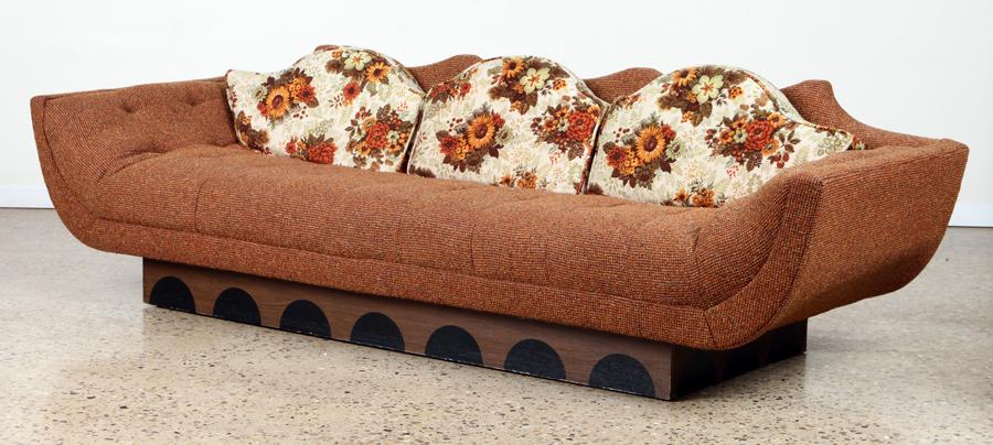 SOFA W/ SCALLOPED BACK EBONIZED DECORATION 1960: A mid century modern sofa having scalloped back and resting on a mahogany platform base with ebonized decoration circa 1960. Ensuite Ht: 28" Wd: 96" Dpth: 32.5" Seat: 17"