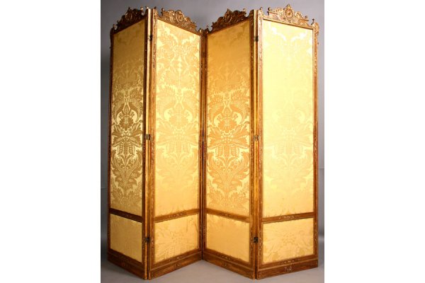 Antique French 4 paneled double sided screen: Very good antique French four paneled double sided folding screen circa 1890. Having a highly carved giltwood frame with shell carved medallion, and classical scroll decoration supported on molded sid