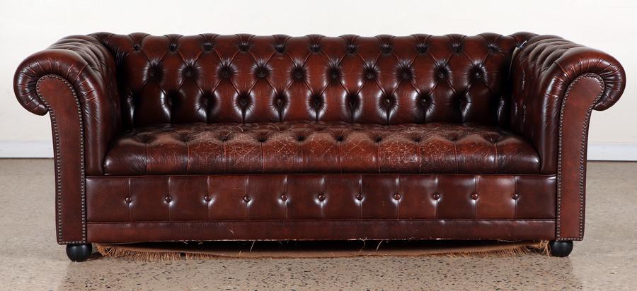 CHESTERFIELD BROWN LEATHER SOFA STUD DECORATION: A Chesterfield brown leather sofa having button and brass stud decoration. Ht: 28" Wd: 76.75" Dpth: 33.75" Seat: 16.25"