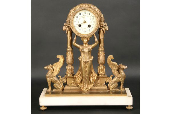 NEOCLASSICAL ANTIQUE FRENCH BRONZE MARBLE CLOCK: Neoclassical style 19th century French bronze and marble mantle clock with rams' head columns, griffins and a porcelain face. Ht: 17" Width: 14.5" Depth: 6" ***PLEASE NOTE: All property shall be paid