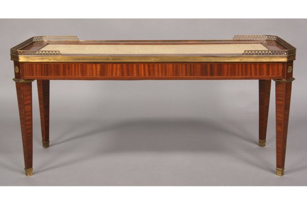 FRENCH COFFEE TABLE LEATHER TOP BANDED INLAY: French Louis XVI style coffee table with inset leather top framed by banded inlay and brass gallery circa 1940. Supported on bronze mounted tapered legs. Ht: 19" Width: 40.5" Depth: 17" ***PLEASE NOTE