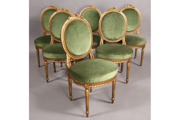 SET 6 ANTIQUE FRENCH BALLOON BACK DINING CHAIRS: Set of six French Louis XVI style giltwood carved ballon back dining chairs with floral carving, shaped seats and fluted legs circa 1910. Ht: 39" Width: 20" Depth: 18" ***PLEASE NOTE: All property sh