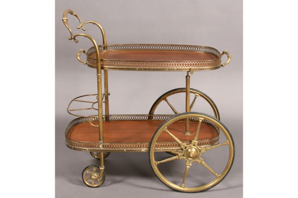 2 TIER REGENCY STYLE MAHOGANY BRASS TEA CART: A two-tiered Regency style mahogany band brass tea cart with raised handle and spoked wheels circa 1960. Ht: 32" Width: 31.5" Depth: 17" ***PLEASE NOTE: All property shall be paid for by the purchaser