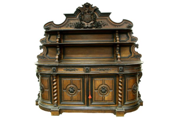 FRENCH CARVED WALNUT EBONIZED BUFFET SERVER: A very good French carved walnut and ebonized buffet with highly detailed family crest circa 1890. having a rampant lion over cross sword shield seated in a cartouche flanked by floral carving over tw