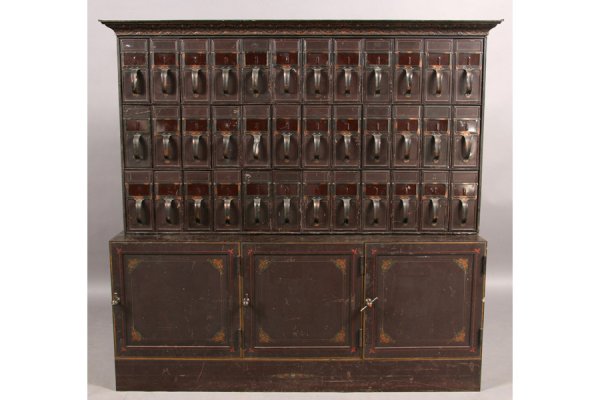 36 DRAWER PAINTED STENCILED IRON FILING SYSTEM: Thirty-six drawer painted and stenciled iron filing system, the doors painted "Fred B. Bernard & Co. St. Louis, MO." circa 1910. Having a shell decorated cornice over twenty-one file drawers resting o