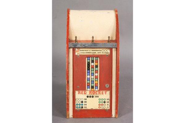 VINTAGE COIN OPERATED RED ROCKET MARBLE MACHINE: Vintage coin operated Red Rocket marble machine with original Indian decals. Remains of paint. Ht: 21" Width: 10.5" Depth: 13" ***PLEASE NOTE: All property shall be paid for by the purchaser within fi